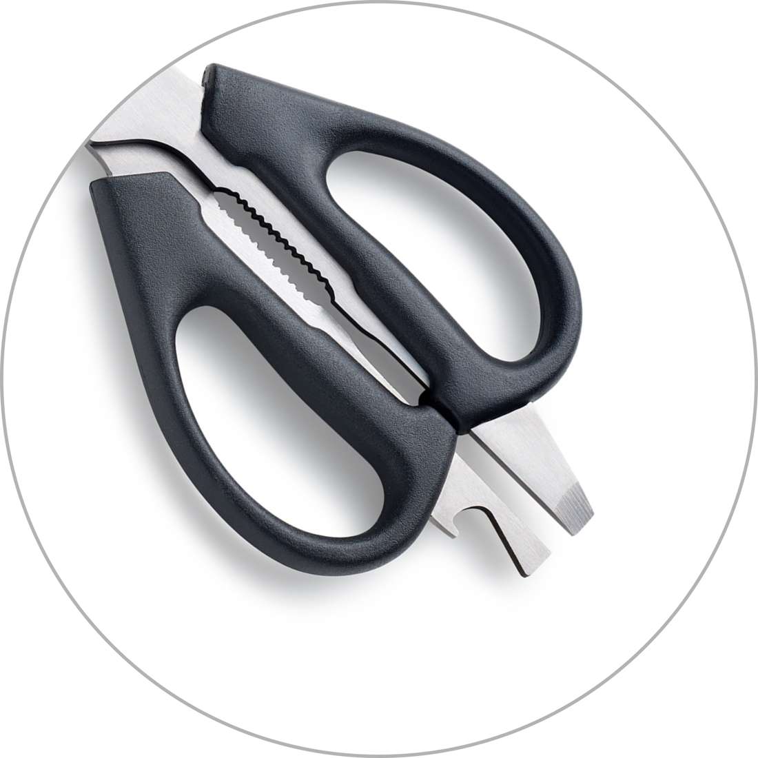 Nahaufnahme der Kuppels SELECTION Allzweckschere mit scharfen Klingen, schwarzen Griffen, einem Flaschenöffner und einem gezackten Abschnitt in der Nähe der Klingen, dargestellt auf weißem Hintergrund in einem runden Rahmen.